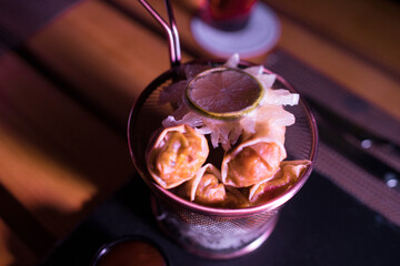Crispy Briouats on a metallic bowl on the table