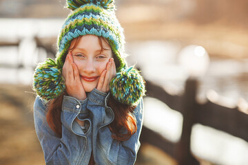 Funny redhaired girl. Red haird teenager. Cheerful girl on fall background.
