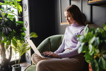Freelancer job to surf the internet computer. The female manager at the hotel hostel uses a laptop...