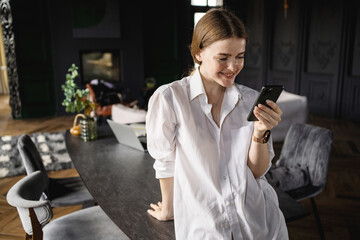 Freelancer work surfing the Internet on a device. The female manager at the hotel hostel uses the...