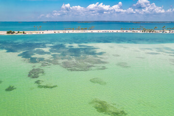 Fototapeta na wymiar Paradise Summer vacation. Florida beach. Panorama of Dunedin Causeway, Honeymoon Island State Park. Blue-turquoise color of salt water. Ocean or Gulf of Mexico. Tropical Nature. America. Aerial view