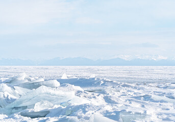 Winter landscape with mountains and Lake Baikal in Siberia at sunset. Natural background.