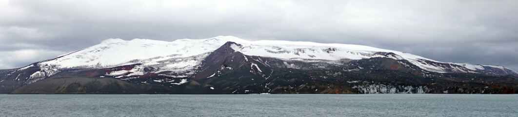 Panorama of snow covered peaks around a crater bay in Deception Island, South Shetland Islands,...