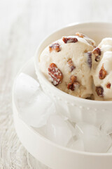 Bowl of Butter Pecan Ice Cream with Soft Light White Background
