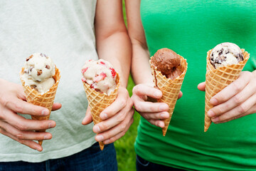 Two People Holding Ice Cream Cones Outside in Summer