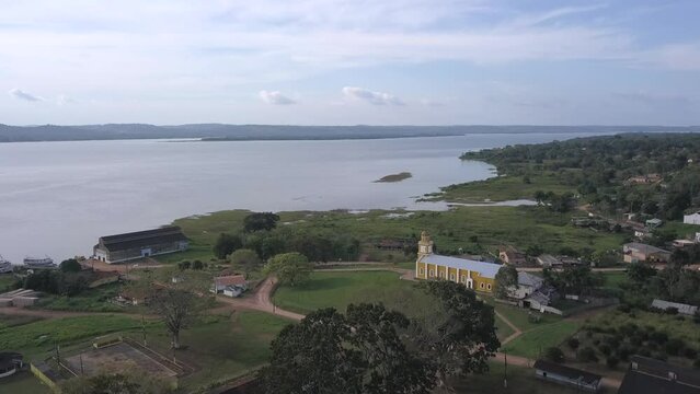 Drone aerial view of Fordlandia city skyline in Amazon rainforest, Brazil. Tapajos river and historic water tank tower. Town built by Henry Ford in 1928 to produce rubber in the middle of the forest.