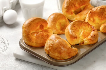 Yorkshire pudding in baking dish, in muffin cups. Homemade traditional English food. Grey...