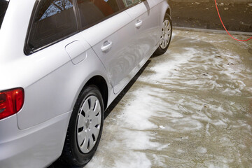 Car wash, a lot of active foam on the car and on the ground