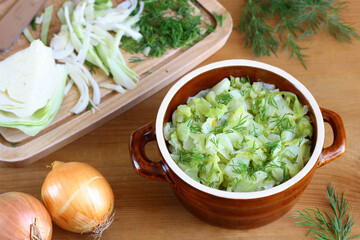 Stewed young cabbage sprinkled with chopped dill. Spring vegetable dishes. Vegetarian cooking