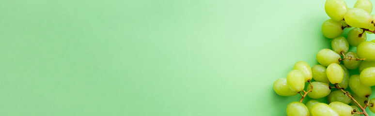 top view of ripe and organic grapes on green, banner.