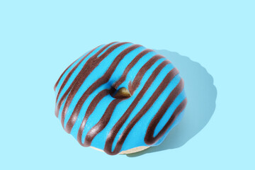 blue donut with glaze on blue pastel background
