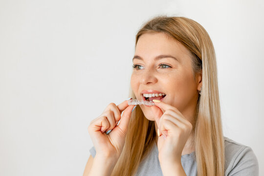 Dental Treatment Concept. Close up of young woman holding invisible aligner, whitening tray, free space