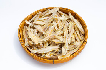 Dried anchovies in bamboo plate on white background.