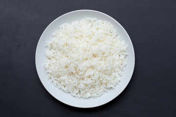 Dish of rice on dark background.