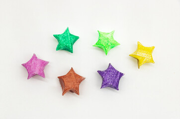 paper made colorful star over on white background, top view
