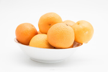 selective focus Tangerine or kamala in a plate isolated on white background,