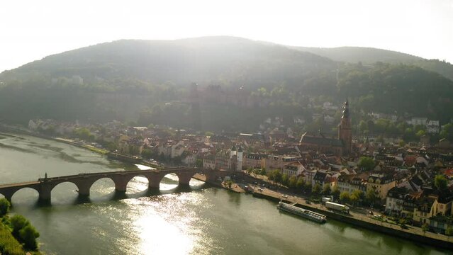 Aerial Shot Of Church And Famous Castle In Town, Drone Flying Forward Over River - Heidelberg, Germany