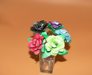 paper made rose in different color isolate on low light background