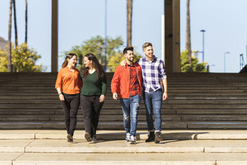 Obraz premium a lesbian and a gay couple walk down the steps of a plaza