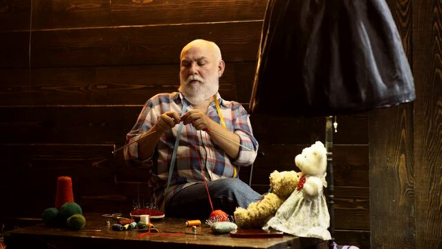 Senior man with knitting needles. Knitting with knit needle, yarn needlework craft. Pension reunion retired concept.