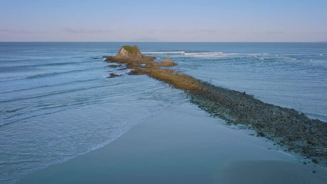 Rocky outpost at the entrance to the estuary, Mangawhai Heads, New Zealand