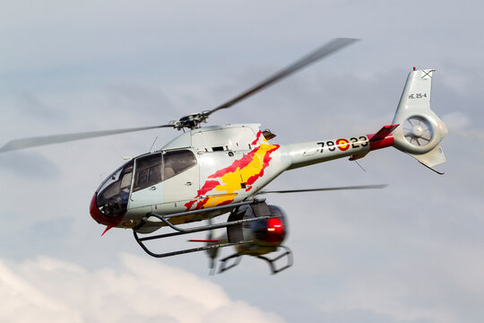 RAF Waddington, Lincolnshire, UK - July 6, 2014: Spanish Air Force Eurocopter EC-120B Colibri helicopter from the Patrulla Aspa display team performing an aerial display.