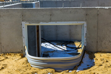 Building unfinished construction window well for basement in new residential home