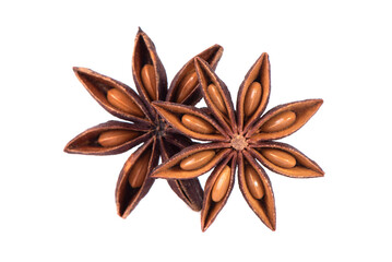 Dry star anise with seeds on a white background in a spoon. Close-up macro shot of star anise...