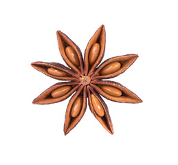 Dry star anise with seeds on a white background in a spoon. Close-up macro shot of star anise spices.
