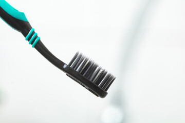 black tooth brush in a bathroom setting closeup 