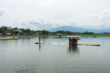 Tourists using raft enjoying Beautiful View of Bagendit Lake in Garut, West Java, Indonesia. Lake Bagendit is a popular tourist destination in Garut Regency.