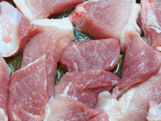 Raw pork meat in pieces. Closeup
