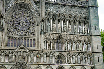 Detail of the Nidarosdomen gothic cathedral in Trondheim, Norway.  grey medieval stone walls with the figures of the saints