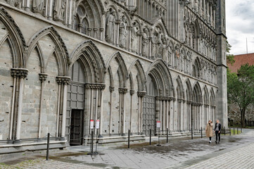 Nidarosdomen gothic cathedral in Trondheim, Norway. grey medieval stone walls and archways with the figures of the saints