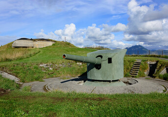 Cannon at Ergan fortress world war II open air museum in Bud, Romdal, Norway. Blue sky with clouds...