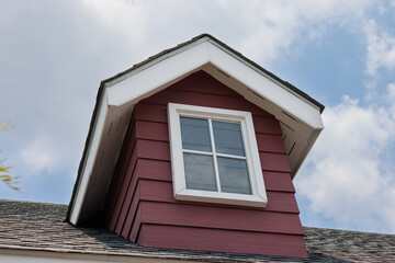 fake window on garret house and roof shingle with rain cloud on blue sky background. Asphalt...