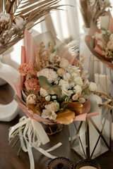 Bouquet in golden hues in the sun. carnation, rose, alstroemeria, dried flowers