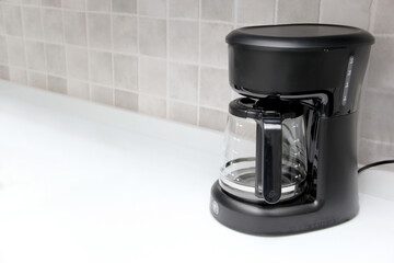Black coffee maker to prepare American coffee with glass jug with reusable filter to put ground...