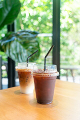 iced black coffee takeaway glass on table in coffee shop cafe restaurant