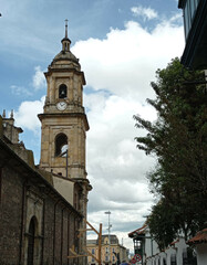 Fototapeta premium Old cathedral tower next to a blue sky in the city