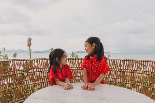 Happy Family On Terrace Balcony With Sea View