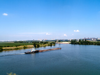 A cargo barge floats on the river