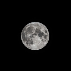 Detailed image of the full moon isolated on black.