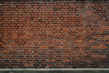 Red big brick wall, surface of stones are rough and cracked,  no person