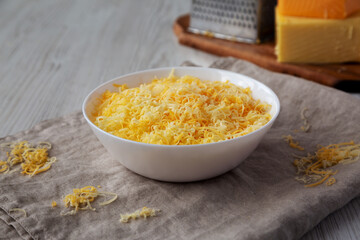 Shredded Mexican Cheese Mix in a White Bowl, side view.