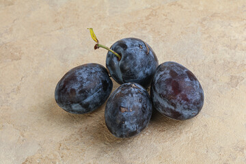 Ripe plum heap over background