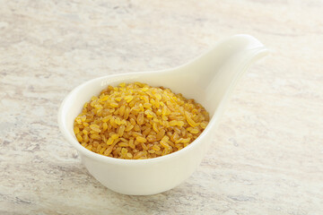 Raw bulgur in the bowl