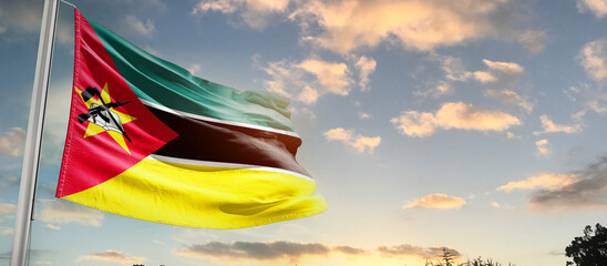Mozambique national flag cloth fabric waving on the sky - Image - obrazy, fototapety, plakaty
