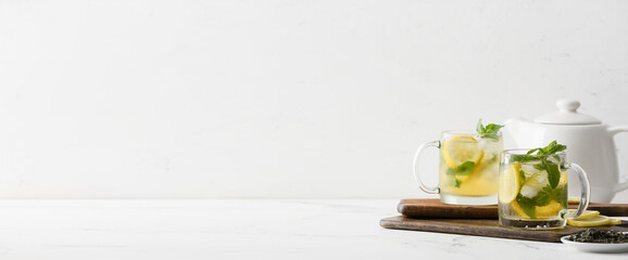 Cups of tasty iced green tea on white background with space for text