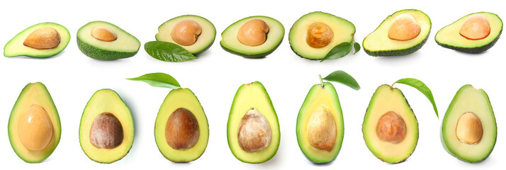 Many halves of fresh avocado isolated on white